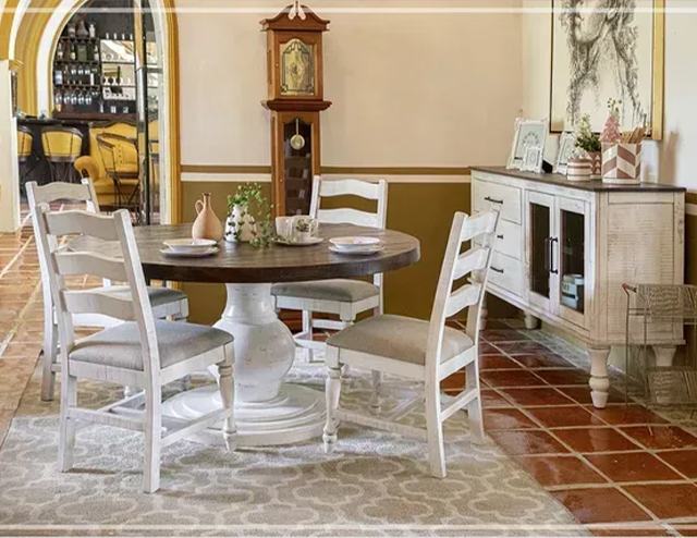 A Hacienda style dining room with a round white dining table and chairs at Fiesta Furnishings in Scottsdale, AZ. 