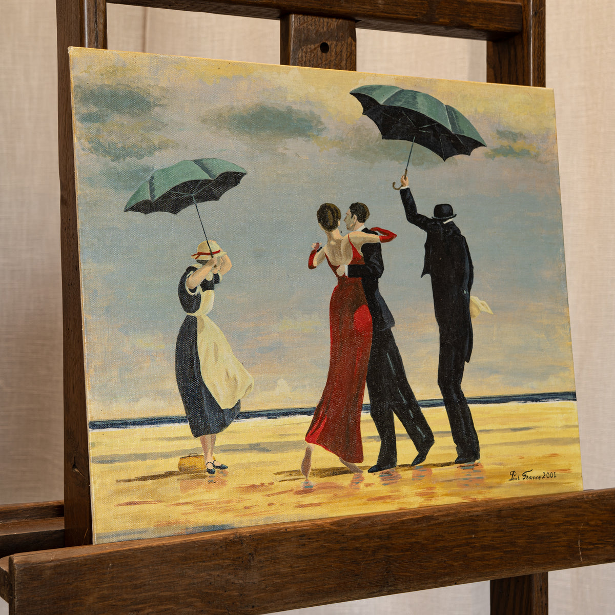 An oil painting on canvas depicting three couples dancing on a beach under a cloudy sky, displayed on a wooden easel. The painting features a woman in a red dress, a man in a black suit, and another couple with green umbrellas, painted in warm yellow, red, black, and blue tones.