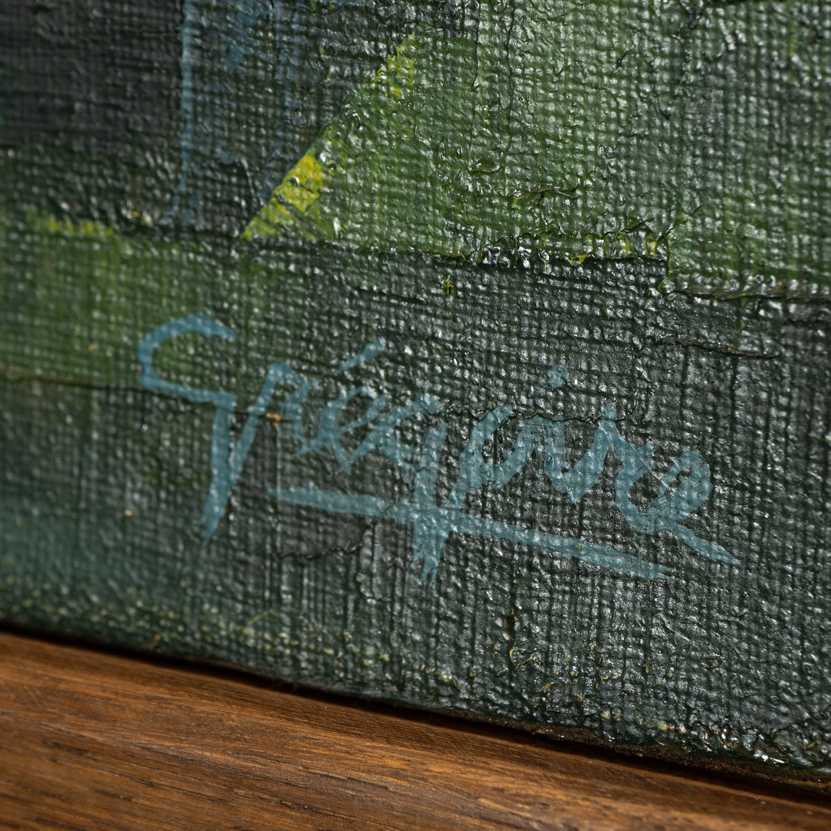 Close-up of a textured canvas painting with a dark green and black background, featuring a light blue cursive signature that reads 'Spire' and a diagonal yellow accent.