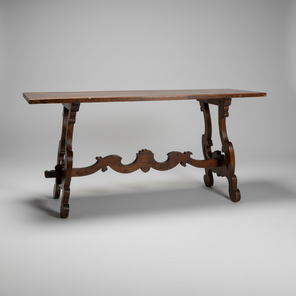 An antique dark brown wooden console table with ornate carved legs and a decorative center stretcher bar, photographed on a neutral gray studio background.
