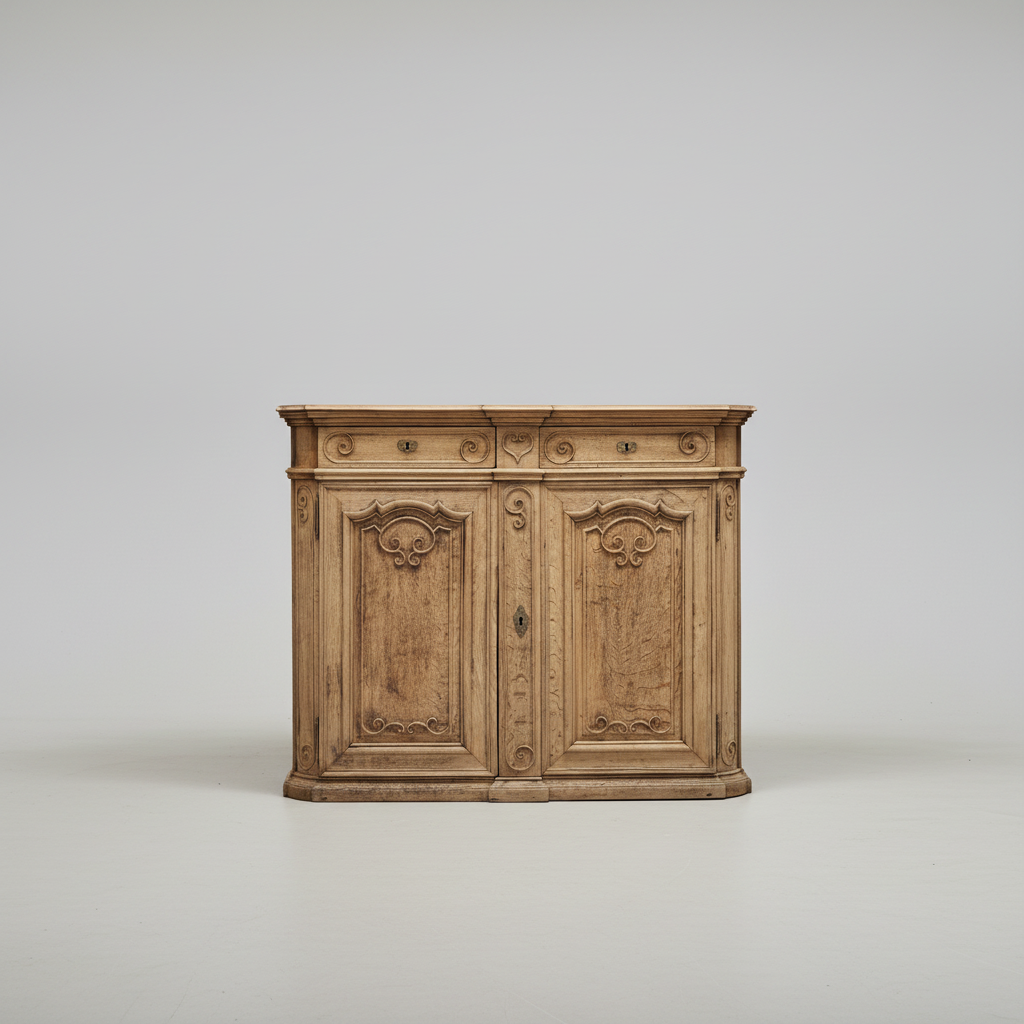 A small vintage-style wooden cabinet with two carved doors and ornate detailing, photographed against a plain light gray studio background.
