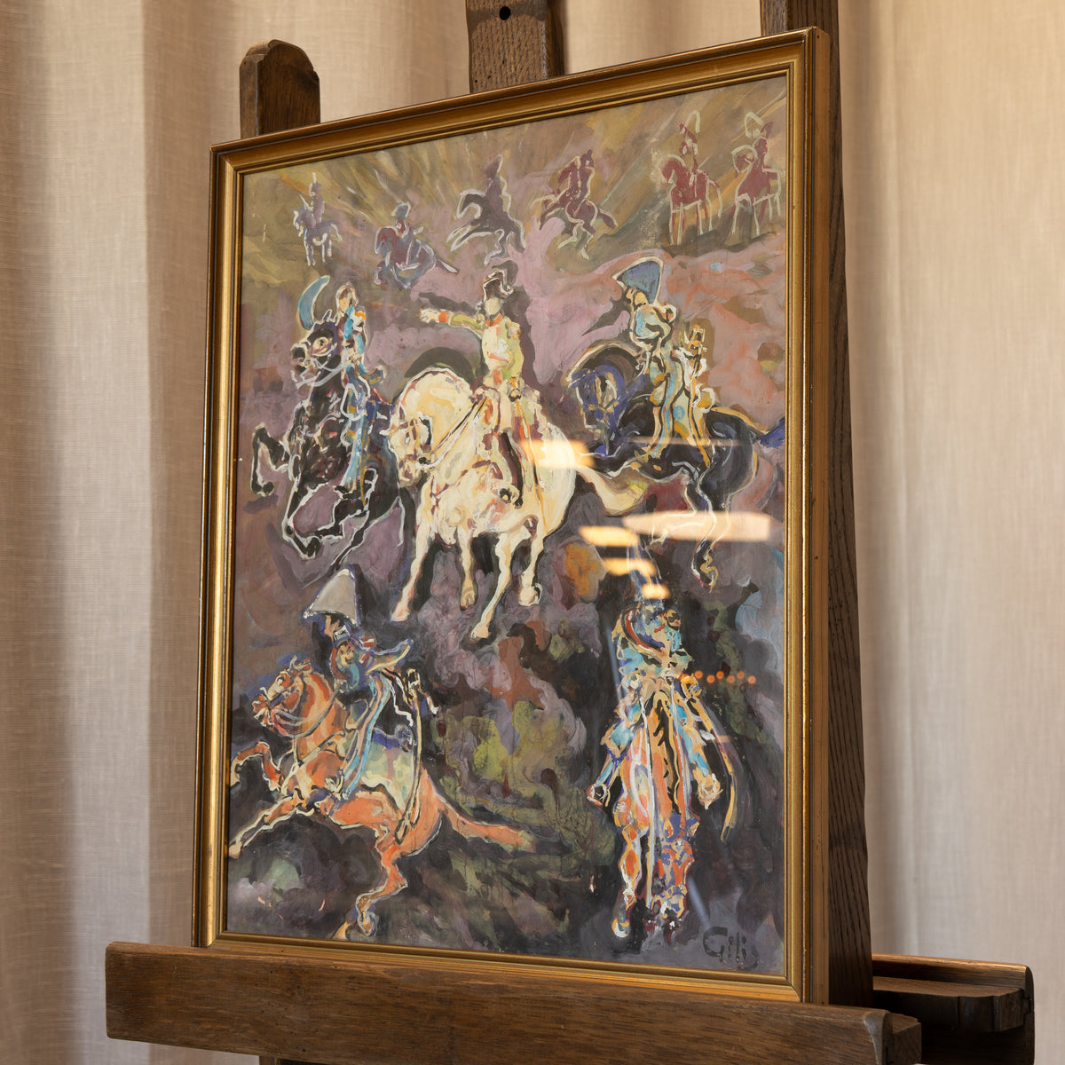 A framed painting on an easel, depicting a dramatic scene of mounted figures in motion with expressive brushstrokes in purple, gold, blue, and brown tones.