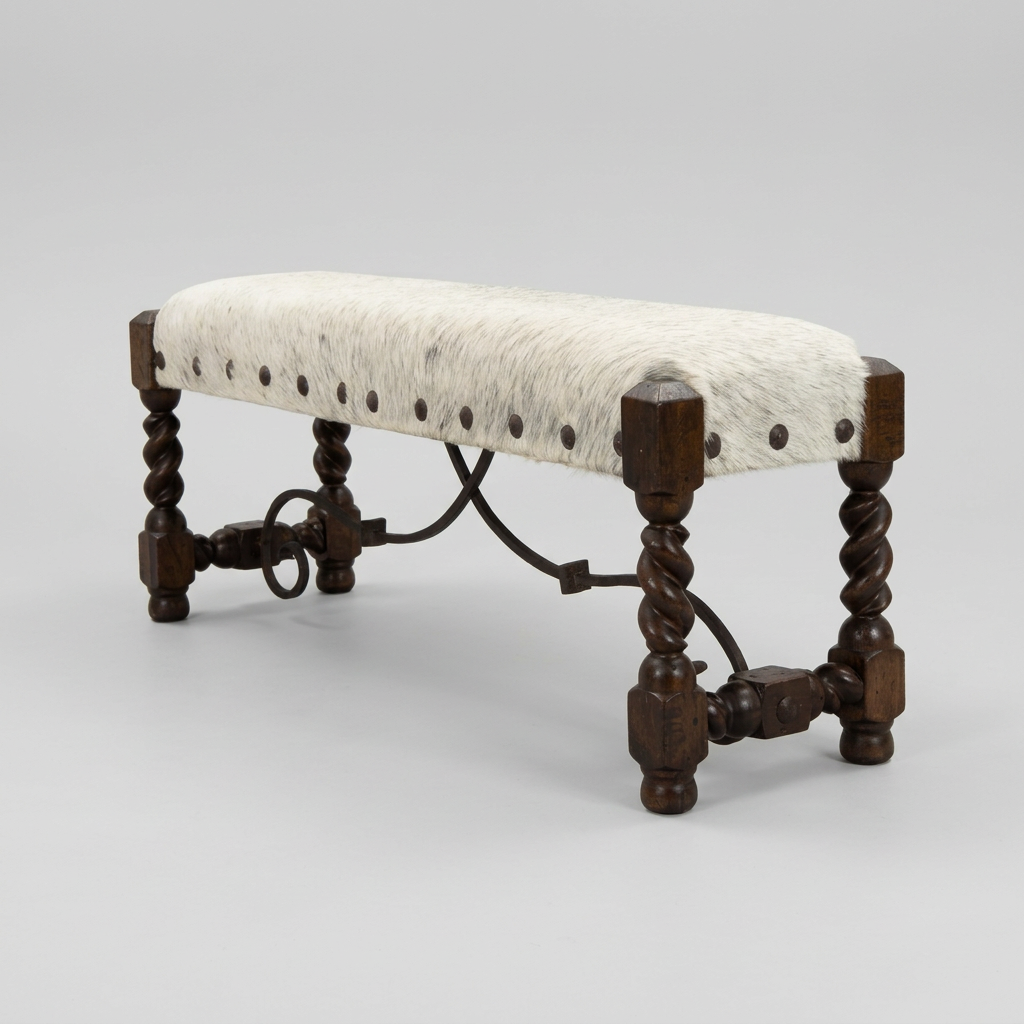A rustic wooden bench with a white cowhide upholstered seat, featuring dark brown twisted legs and metal nail accents, set against a neutral beige curtain backdrop.
