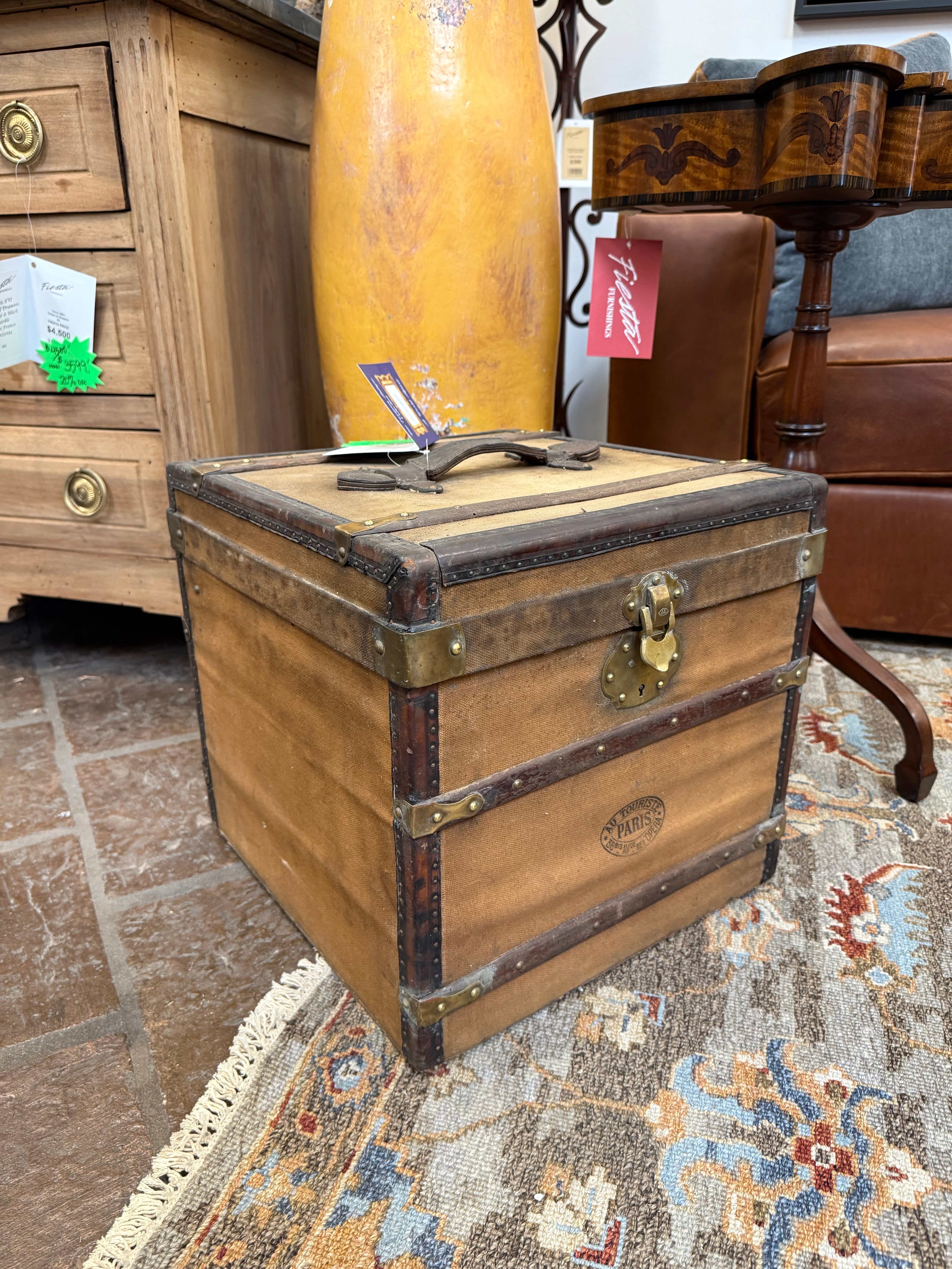 Vintage wooden trunk with brass hardware on a patterned rug