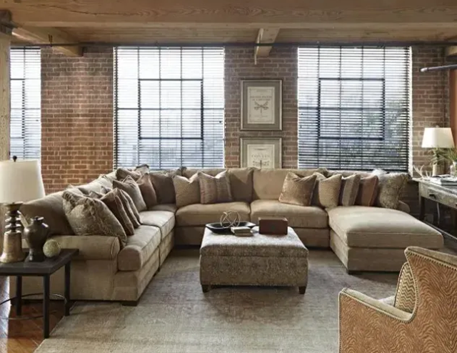 A living room with a large neutral sectional and ottoman at Fiesta Furnishings in Scottsdale, AZ. 