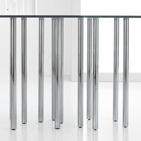 Close-up of a glass table with metal legs on a white background