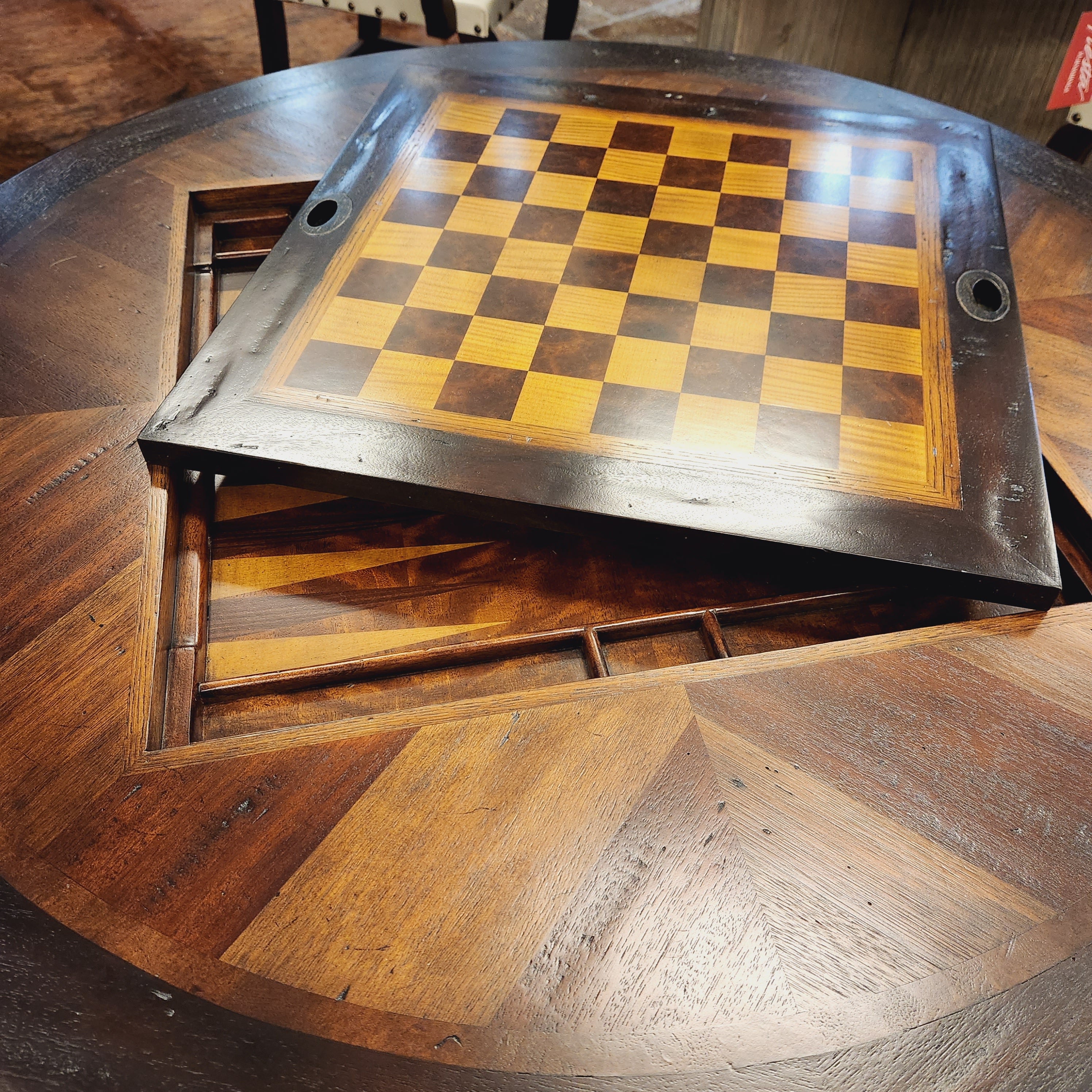 Wooden circular table with a checkered surface