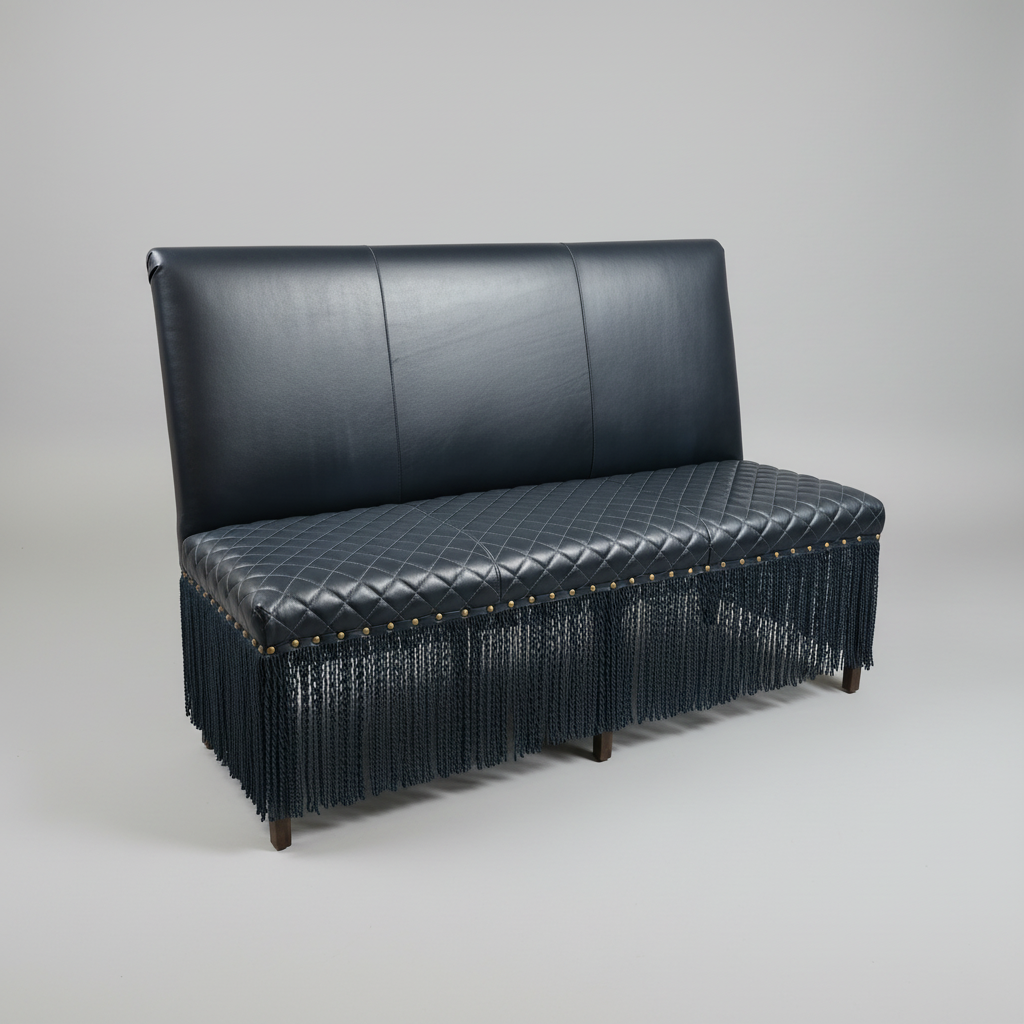 Black leather sofa with fringe on a gray background